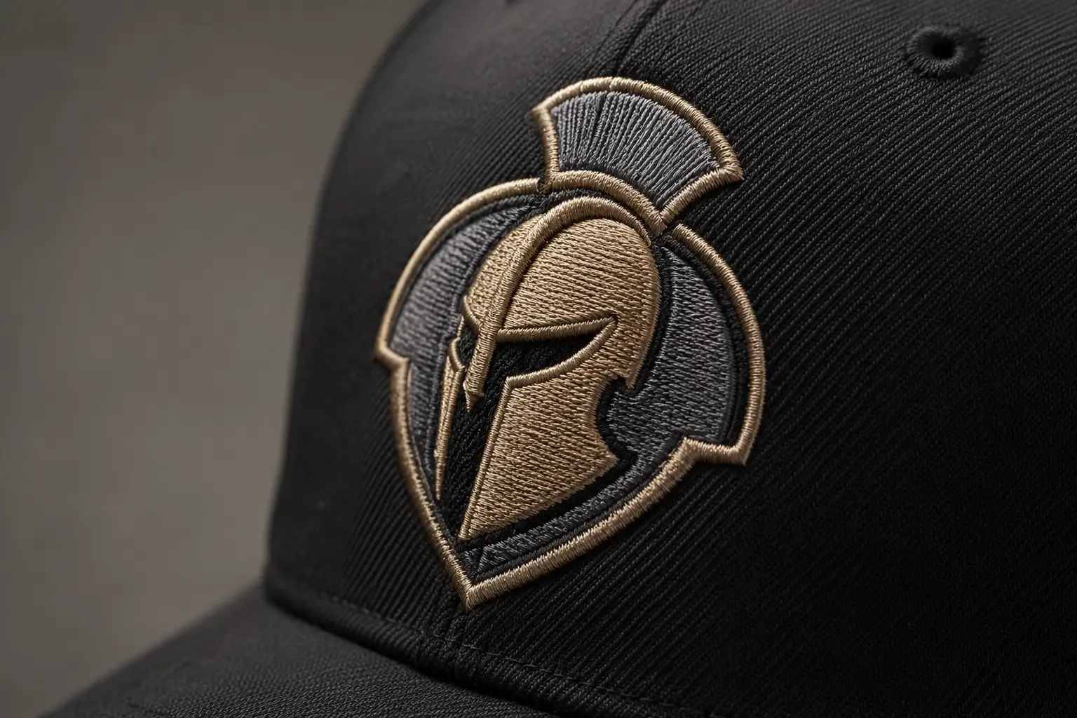 An embroidery machine stitching a logo on a cap