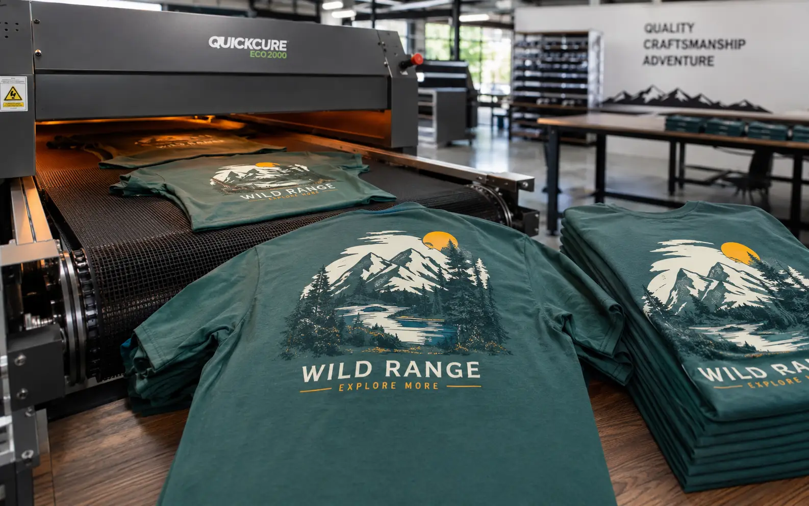 Finished Wild Range tees coming off the conveyor dryer belt